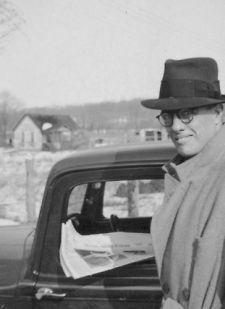 John Avery Lomax, Jr. standing next to car, looking left between 1930 