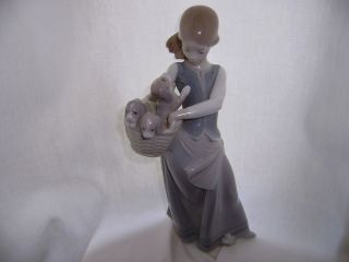 lladro girl with a basket of puppies 