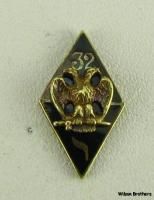 headed eagle set atop two black enameled triangles. One triangle bares 