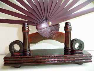 this is a folding fan display stand it s made of wood please note this 