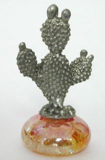 detailed little pewter prickly pear type cactus on a pretty orange 
