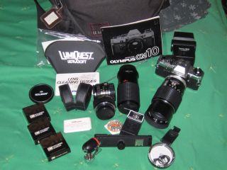 OLYMPUS OM 10 35MM FILM CAMERA WITH MANUAL, MANY ACCESSORIES AND 