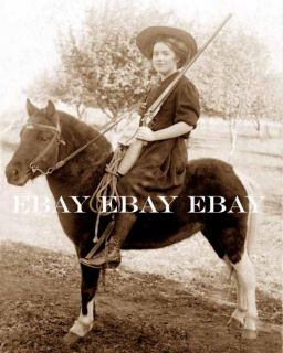 Old West Cowgirl with Her Shotgun Gun and Horse Photo