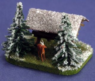 snowy feed station hay rack includes deer figure landscaped base made
